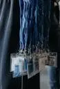 Close-up of blue lanyards with identification badges at an event.